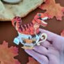 Cherryloco : Orange T Rex Dinosaur Teacup brooch or necklace